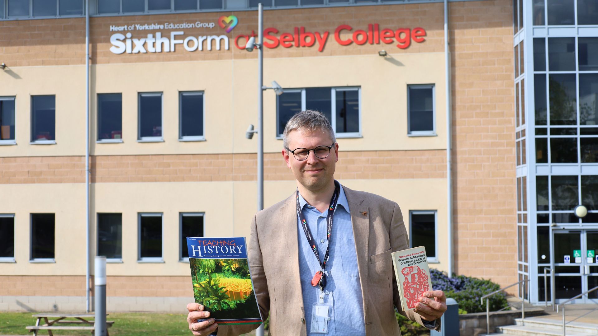 Dr Peter Turner with a copy of History Magazine and the One Day in the Life of Ivan Denisovich book
