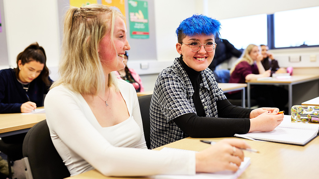 Two female students in a classroom