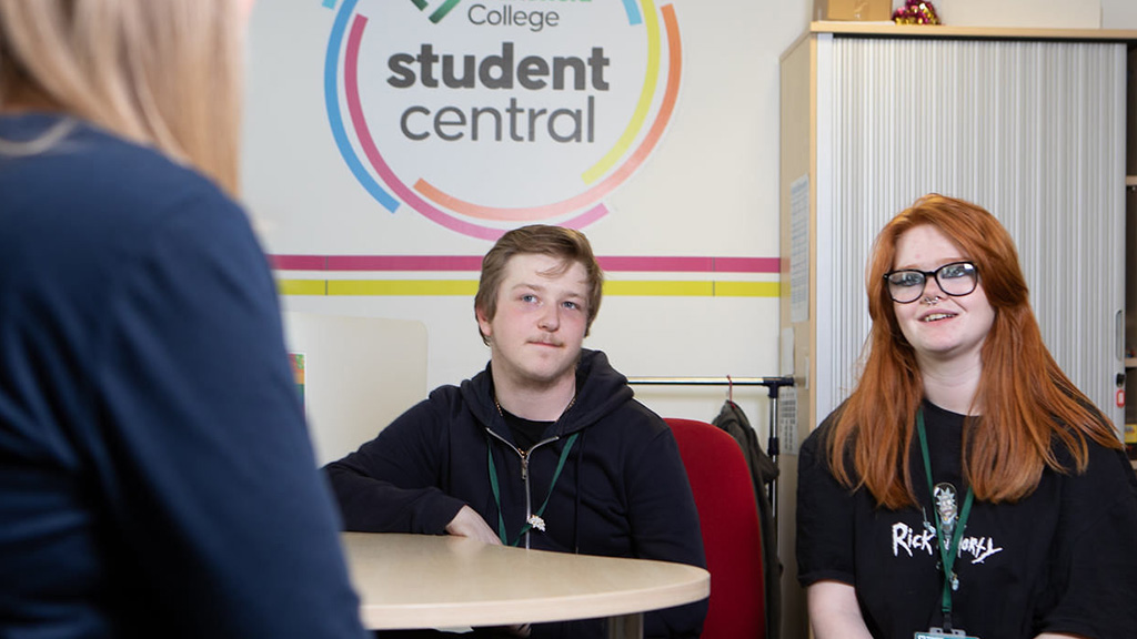 Two students talking to a College advisor